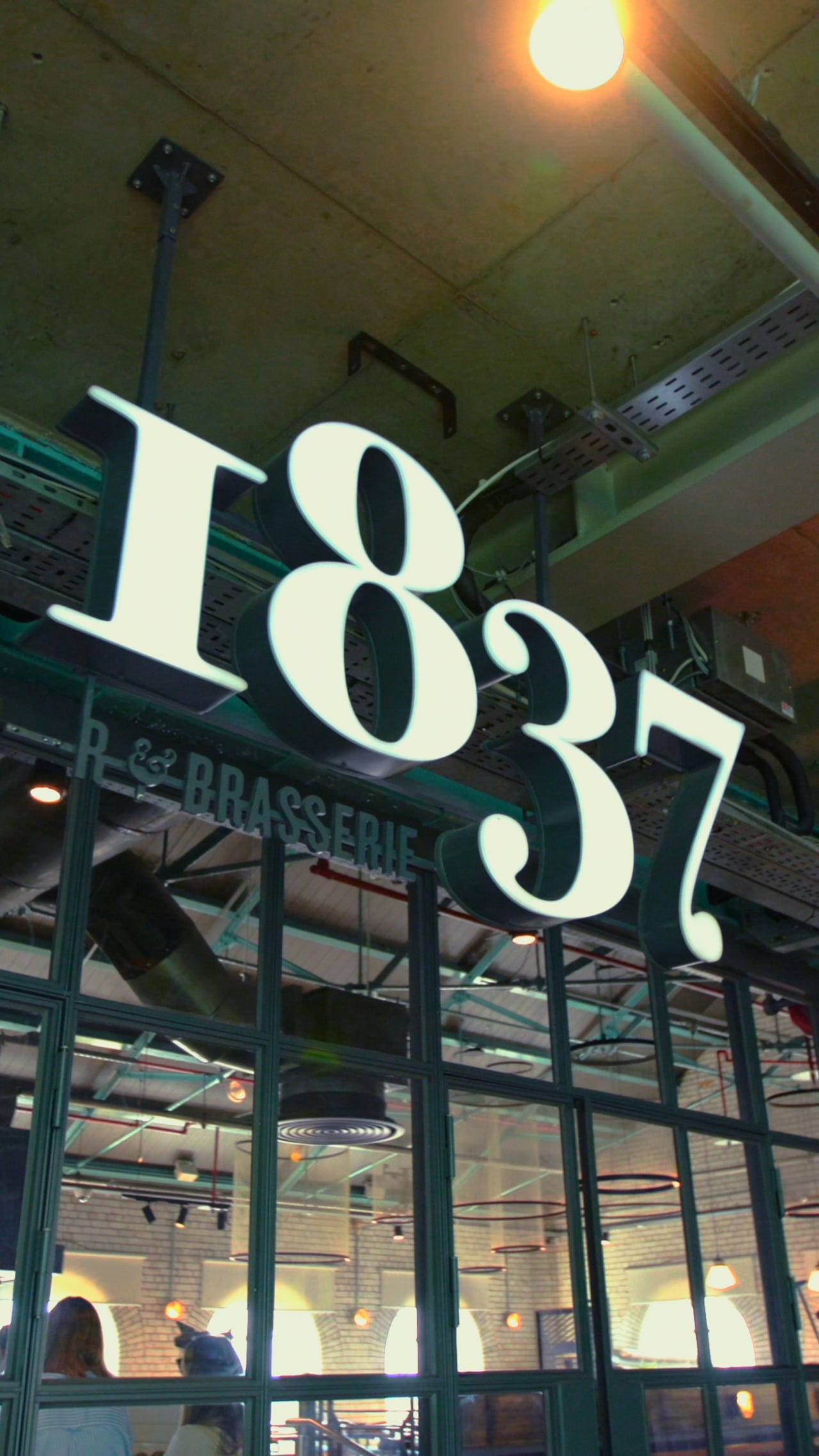 The 1837 Brasserie sign inside the Guinness Storehouse, from the summer menu film.